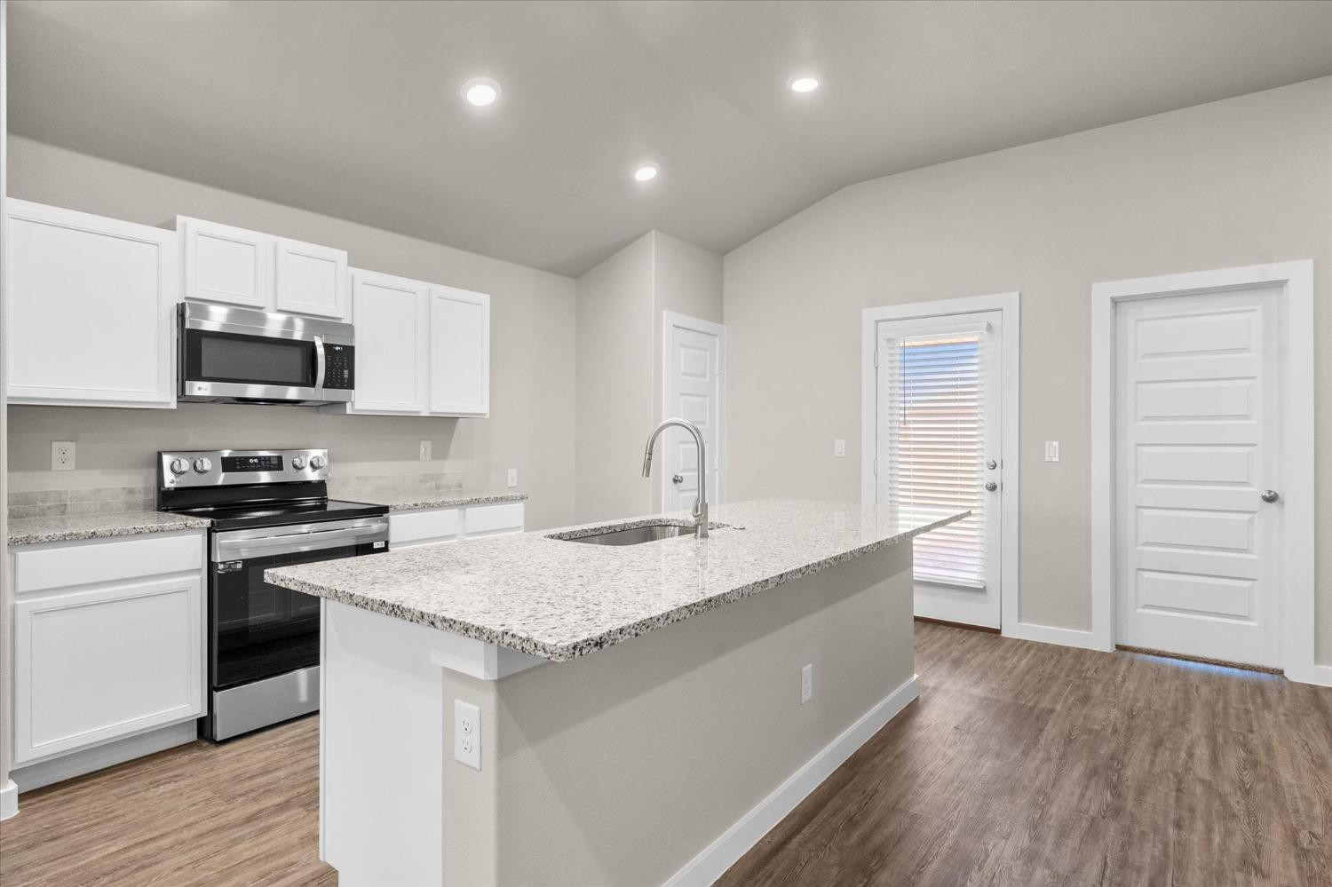 1608 142nd Street Lubbock, TX 79423 - Photo 7 of 20 a kitchen with kitchen island a sink stainless steel appliances and cabinets