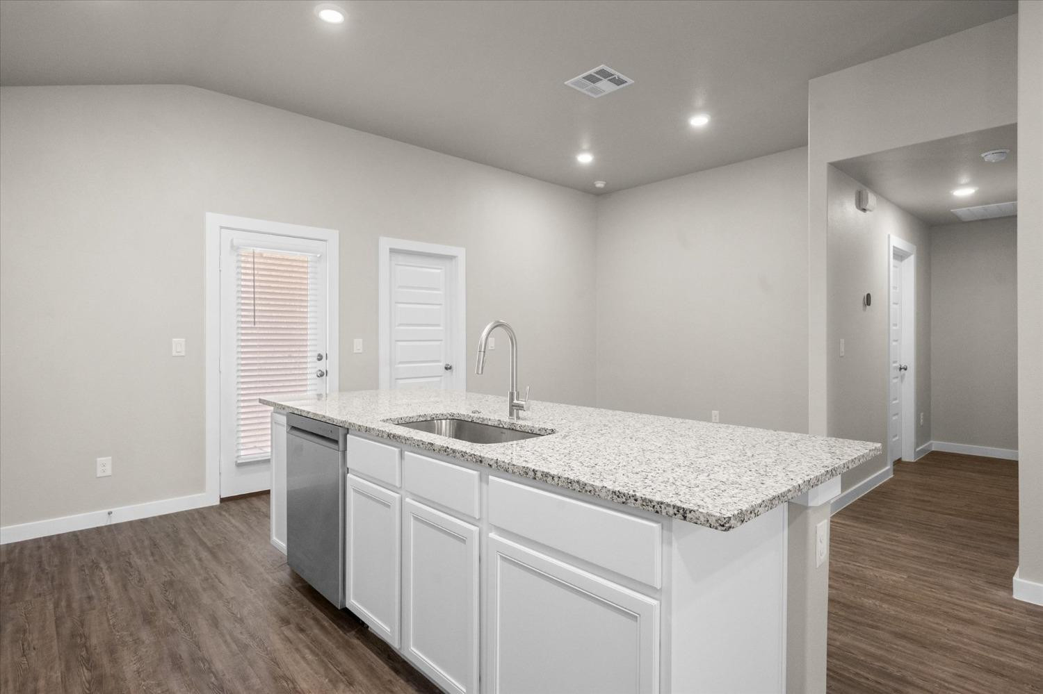 1608 142nd Street Lubbock, TX 79423 - Photo 8 of 20 a kitchen with a sink and wooden floor