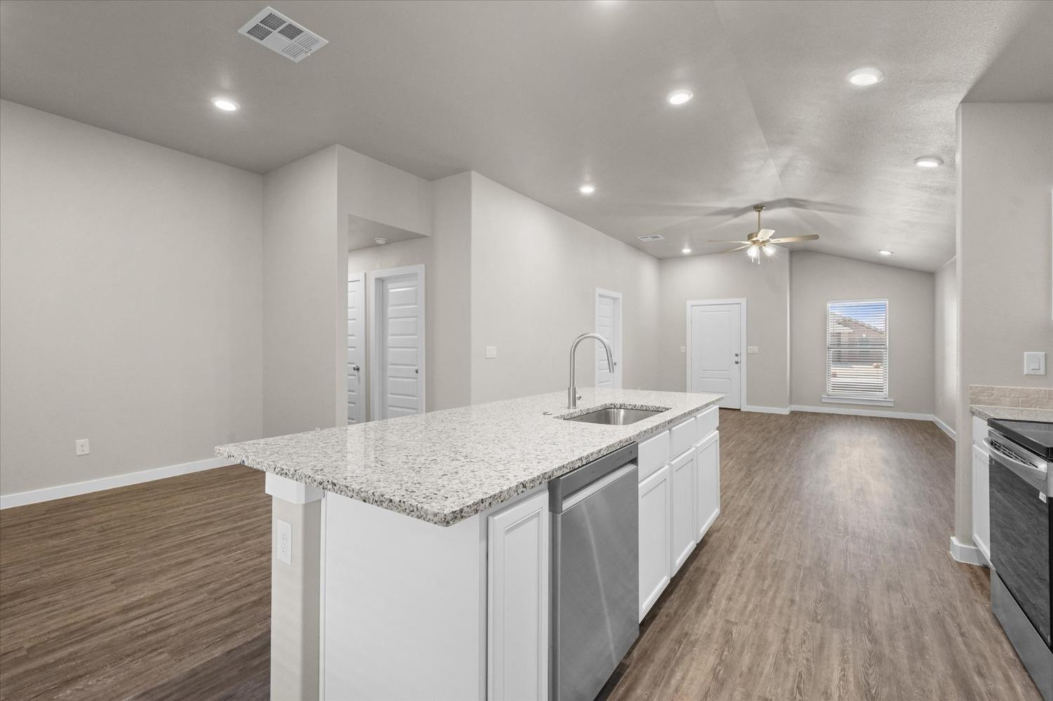 1608 142nd Street Lubbock, TX 79423 - Photo 9 of 20 a view of a kitchen with a sink and wooden floor