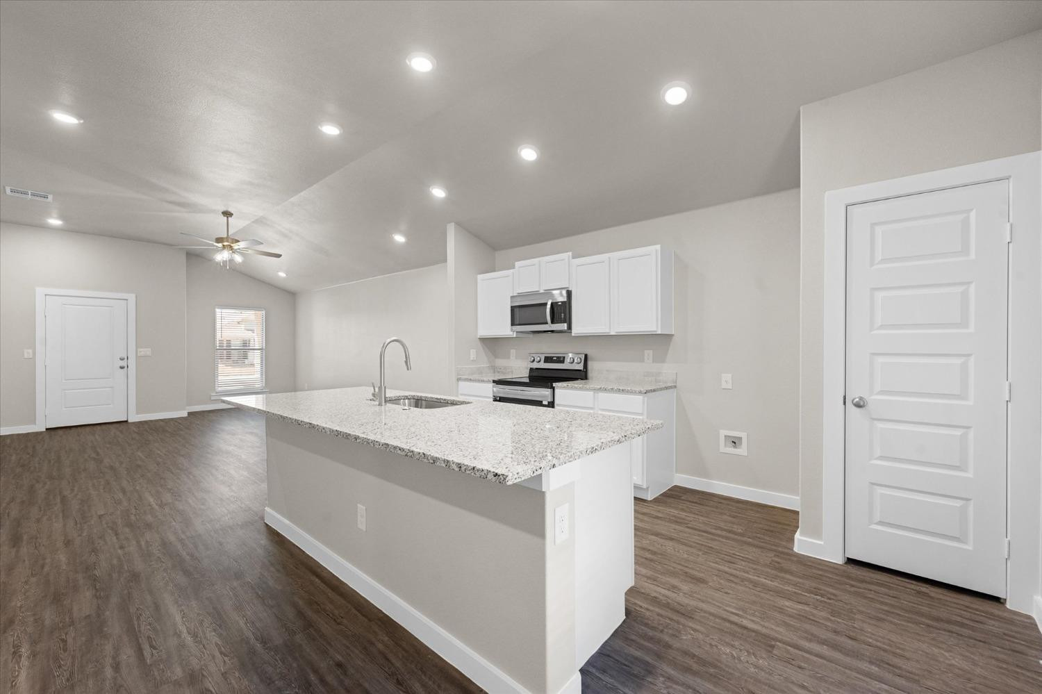 1608 142nd Street Lubbock, TX 79423 - Photo 10 of 20 a view of kitchen with sink microwave and refrigerator