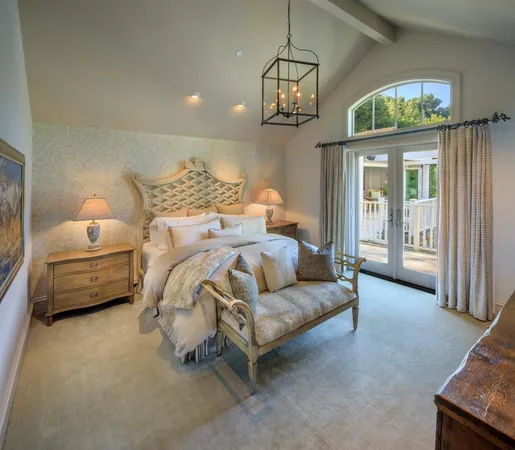 a bedroom with bed and a chandelier