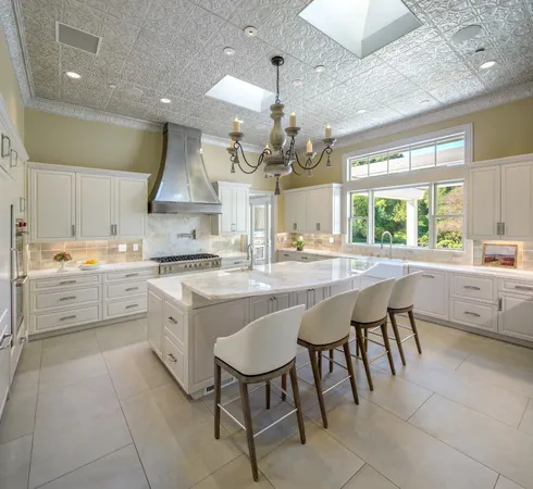 a kitchen with a sink and chairs