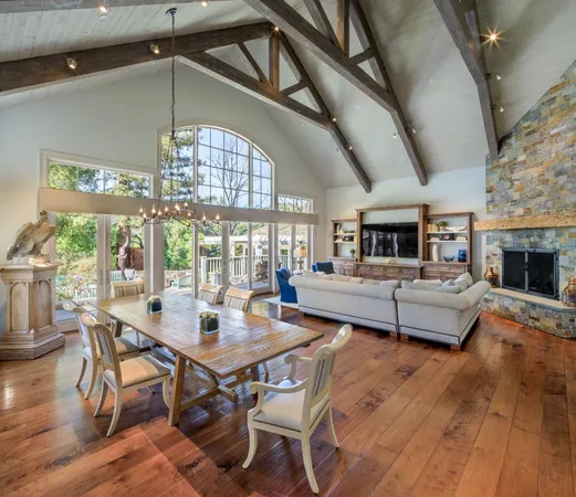 a dining room with furniture a chandelier and wooden floor