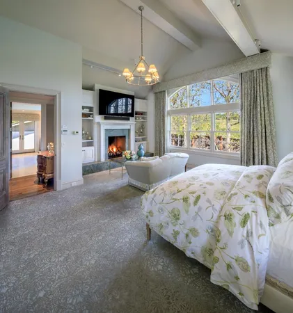 a spacious bedroom with a bed and a large mirror