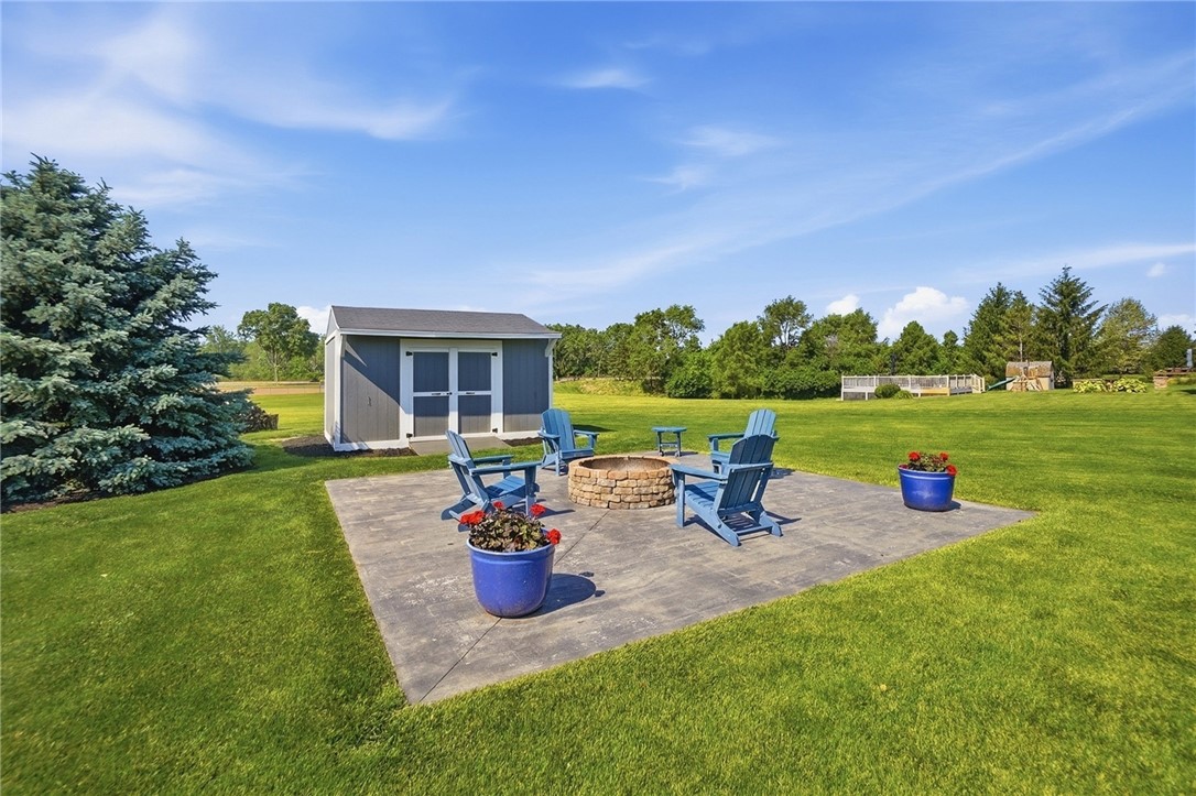 710 Governors Road Troy, OH 45373 - Photo 54 of 56 This serene outdoor space features a patio with a fire pit, perfect for gatherings.
