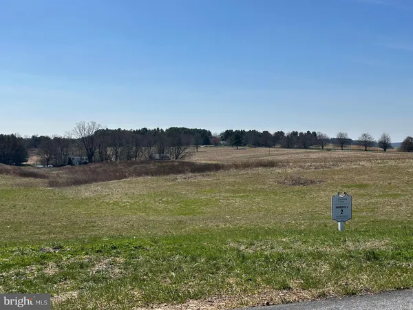 a view of a lake with houses in the back