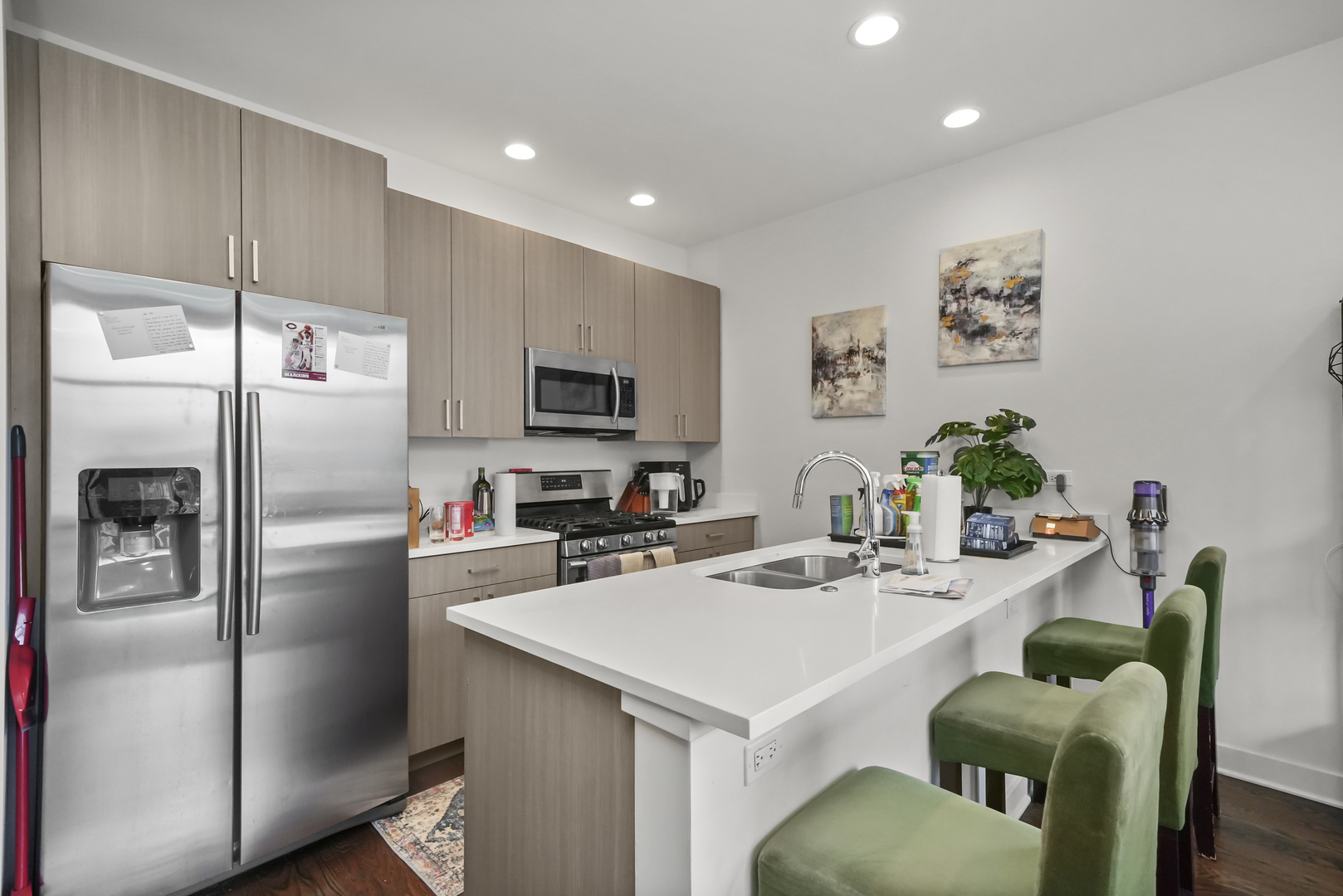 832 West Erie Street, Unit 4W Chicago, IL 60642 - Photo 3 of 8 a kitchen with stainless steel appliances a refrigerator a sink a stove a dining table and chairs