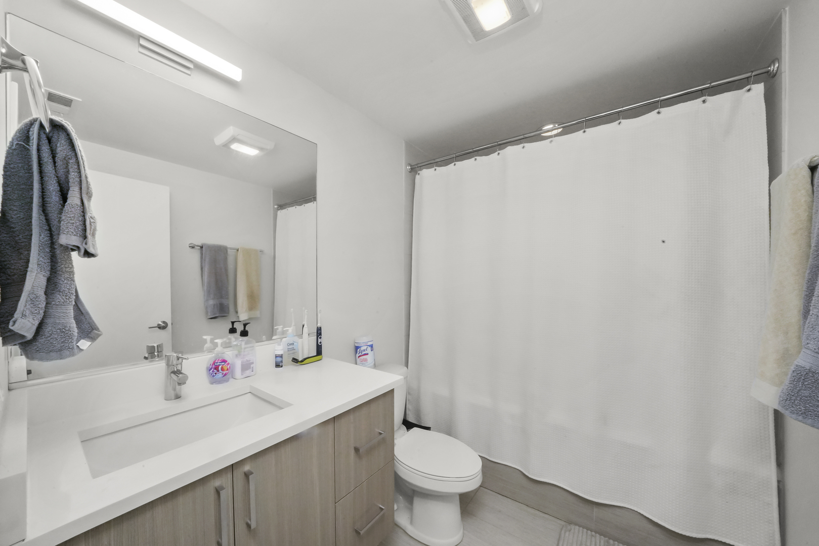832 West Erie Street, Unit 4W Chicago, IL 60642 - Photo 5 of 8 a bathroom with a sink toilet and shower