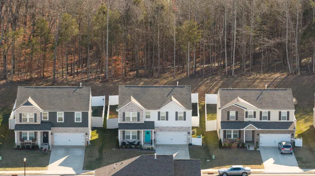 a bedroom with a bed a table and painting on the wall