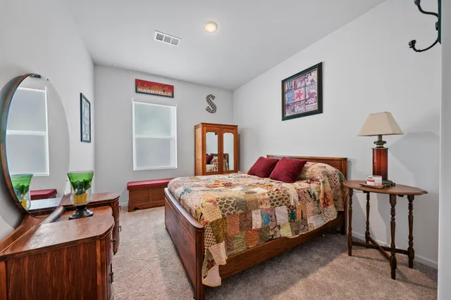 a living room with furniture potted plant and kitchen view