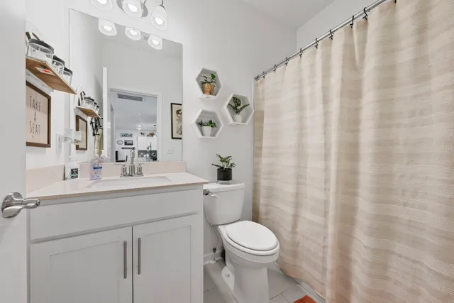 a living room with furniture fireplace and a potted plant