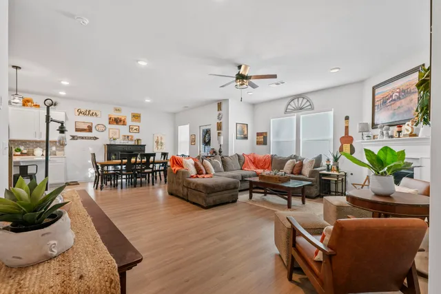 a living room with furniture a fireplace and wooden floor