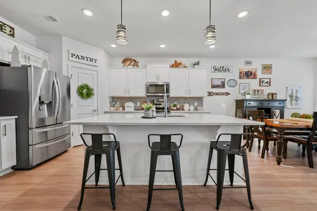 a kitchen with stainless steel appliances a stove a sink and a refrigerator