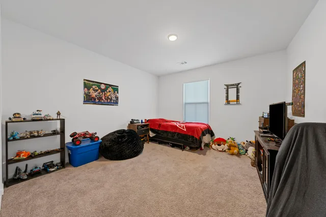 a living room with furniture and a ceiling fan