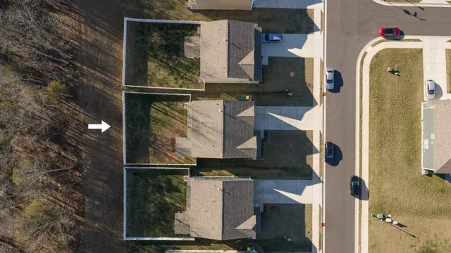 an aerial view of a residential apartment building with a yard