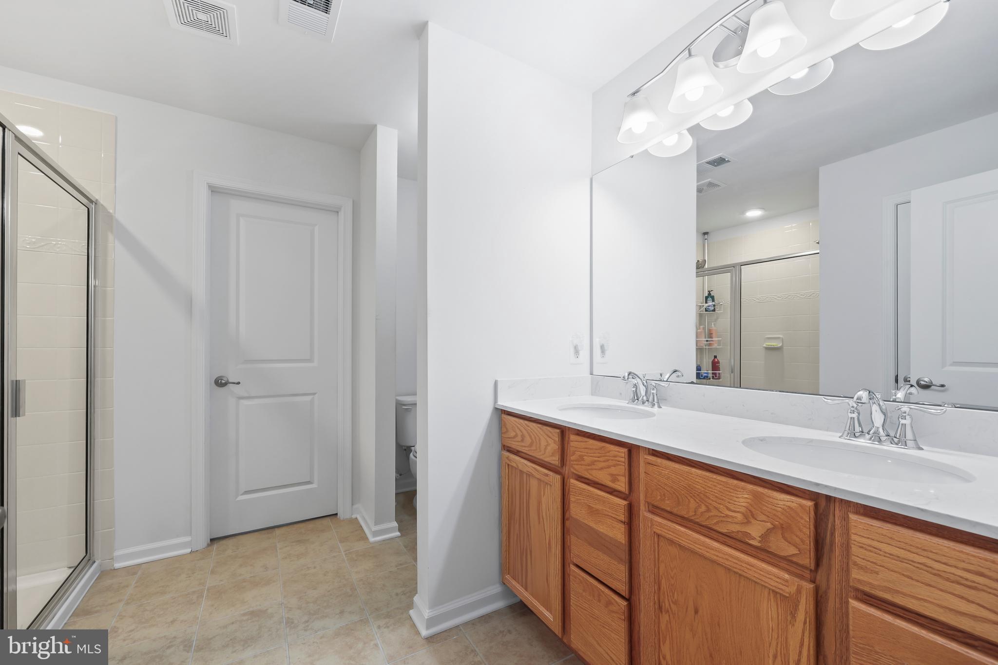 112 Northumberland Drive Stephenson, VA 22656 - Photo 22 of 58 a bathroom with a double vanity sink and a mirror