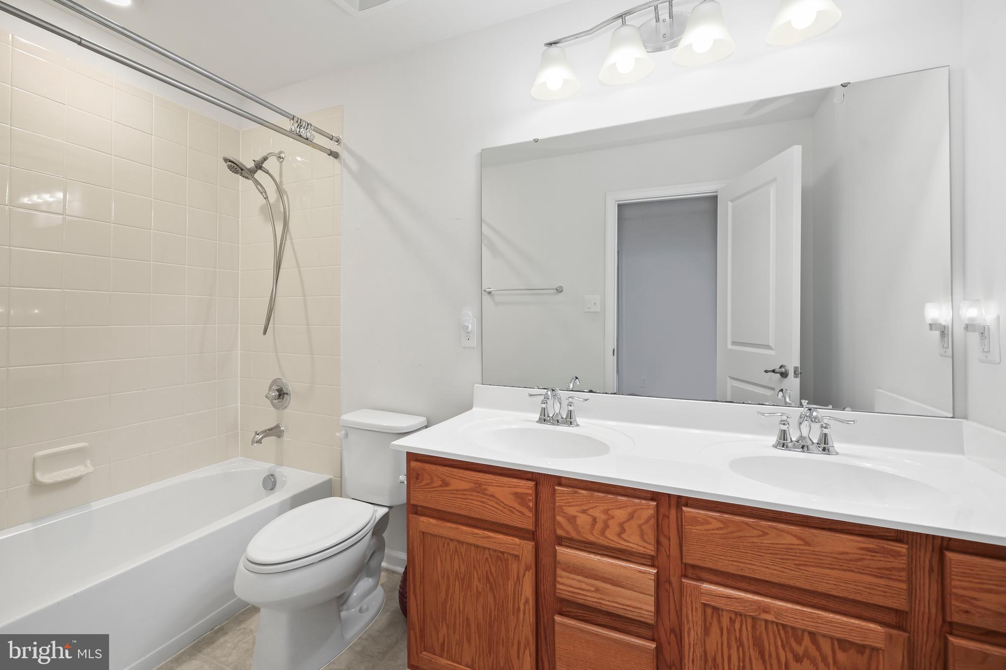 112 Northumberland Drive Stephenson, VA 22656 - Photo 33 of 58 a bathroom with a double vanity sink toilet mirror and shower