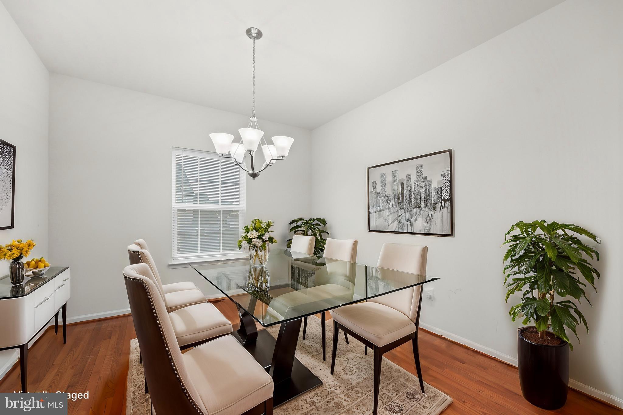 112 Northumberland Drive Stephenson, VA 22656 - Photo 7 of 58 a dining room with furniture potted plants and wooden floor