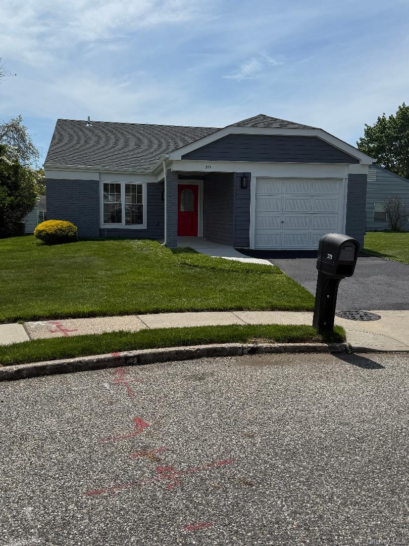 379 Larchmont Court Ridge, NY 11961 - Photo 1 of 17 a front view of a house with a yard and garage