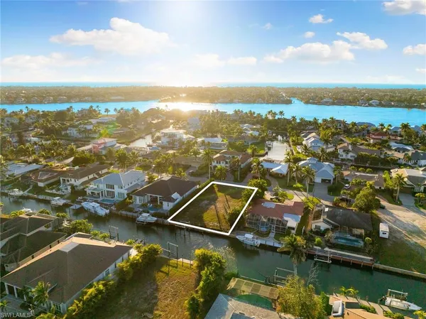 an aerial view of residential houses with lake view