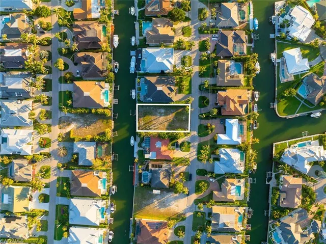 an aerial view of residential houses with lake view