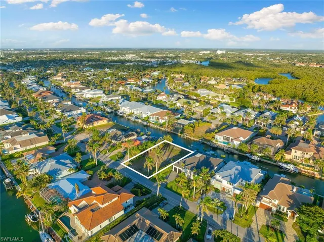 an aerial view of residential houses with outdoor space and swimming pool