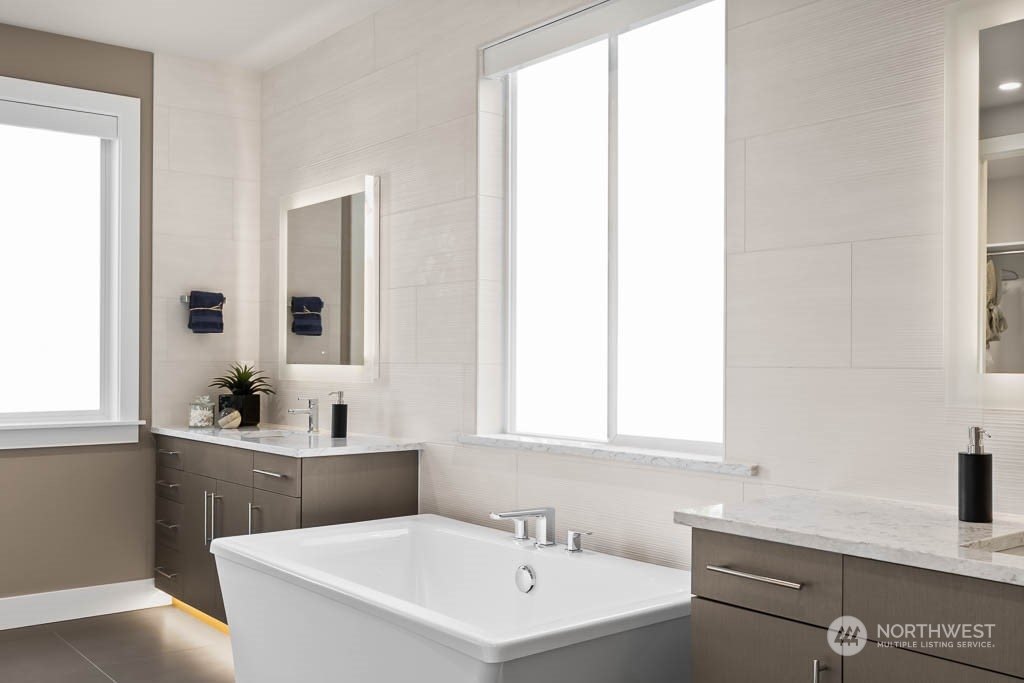 933 131st Place Northeast, Unit 4 Bellevue, WA 98005 - Photo 14 of 18 a bathroom with a sink and a mirror