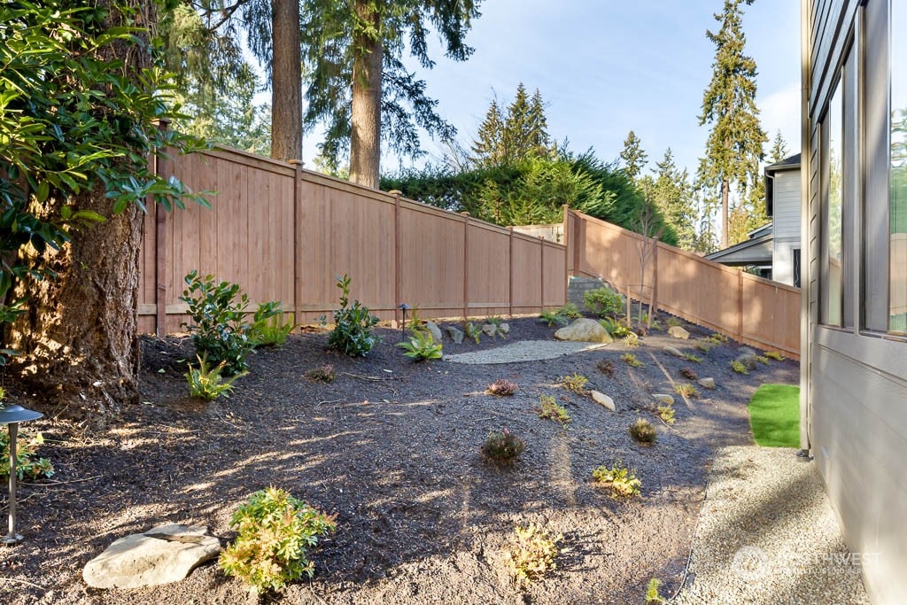 933 131st Place Northeast, Unit 4 Bellevue, WA 98005 - Photo 18 of 18 a view of a backyard with plants and a small yard