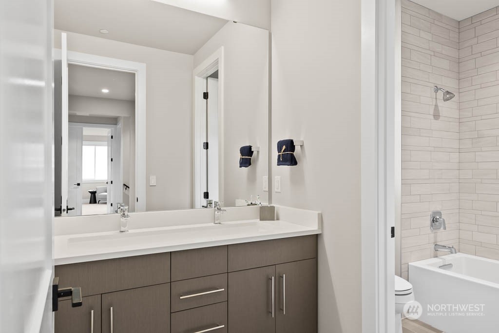 933 131st Place Northeast, Unit 4 Bellevue, WA 98005 - Photo 6 of 18 a bathroom with double sink and a mirror
