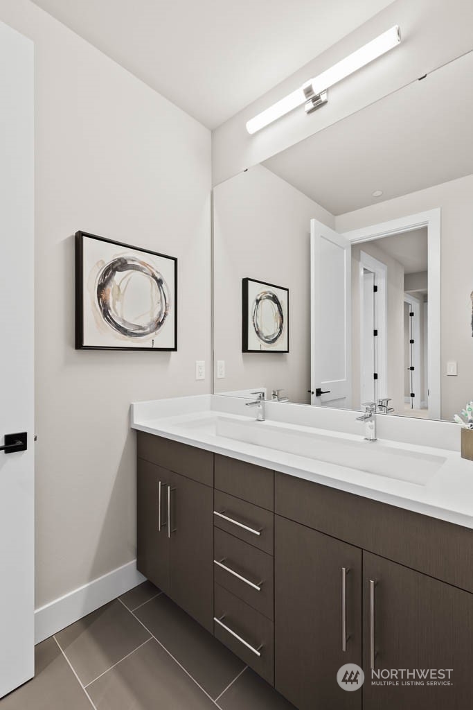933 131st Place Northeast, Unit 4 Bellevue, WA 98005 - Photo 7 of 18 a bathroom with a double vanity sink and a mirror