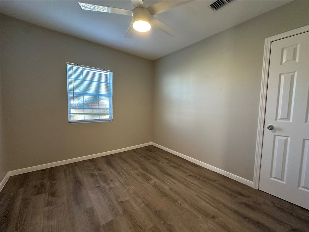 3152 Meadow Lane Robstown, TX 78380 - Photo 12 of 40 an empty room with wooden floor and windows