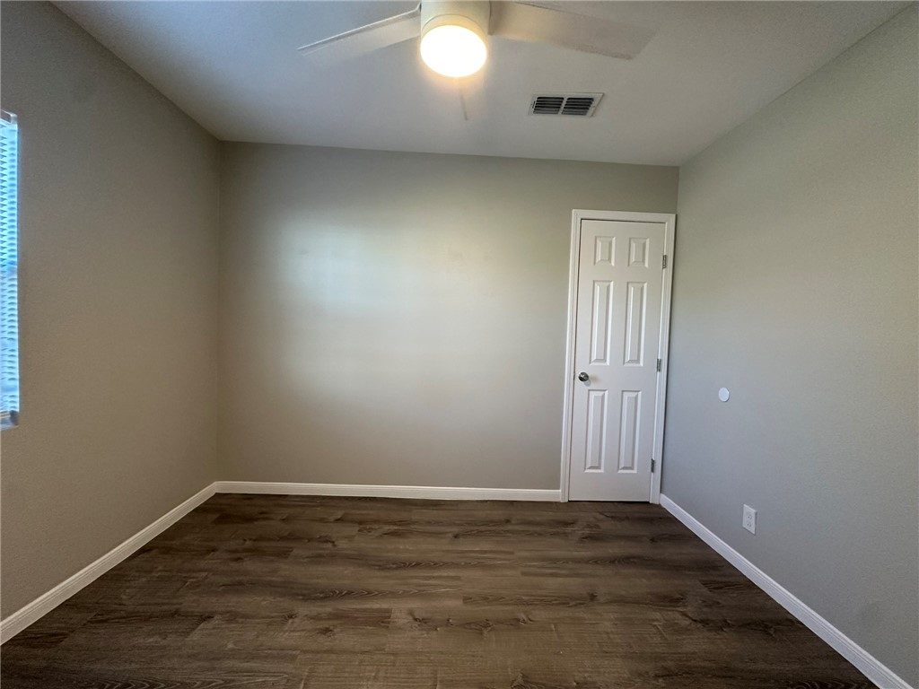 3152 Meadow Lane Robstown, TX 78380 - Photo 14 of 40 an empty room with wooden floor and windows