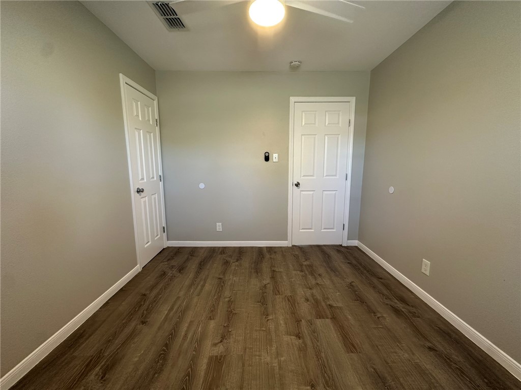 3152 Meadow Lane Robstown, TX 78380 - Photo 16 of 40 a view of an empty room with wooden floor and a window