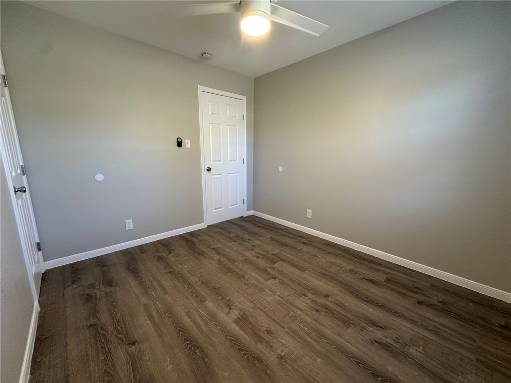3152 Meadow Lane Robstown, TX 78380 - Photo 17 of 40 an empty room with wooden floor and windows