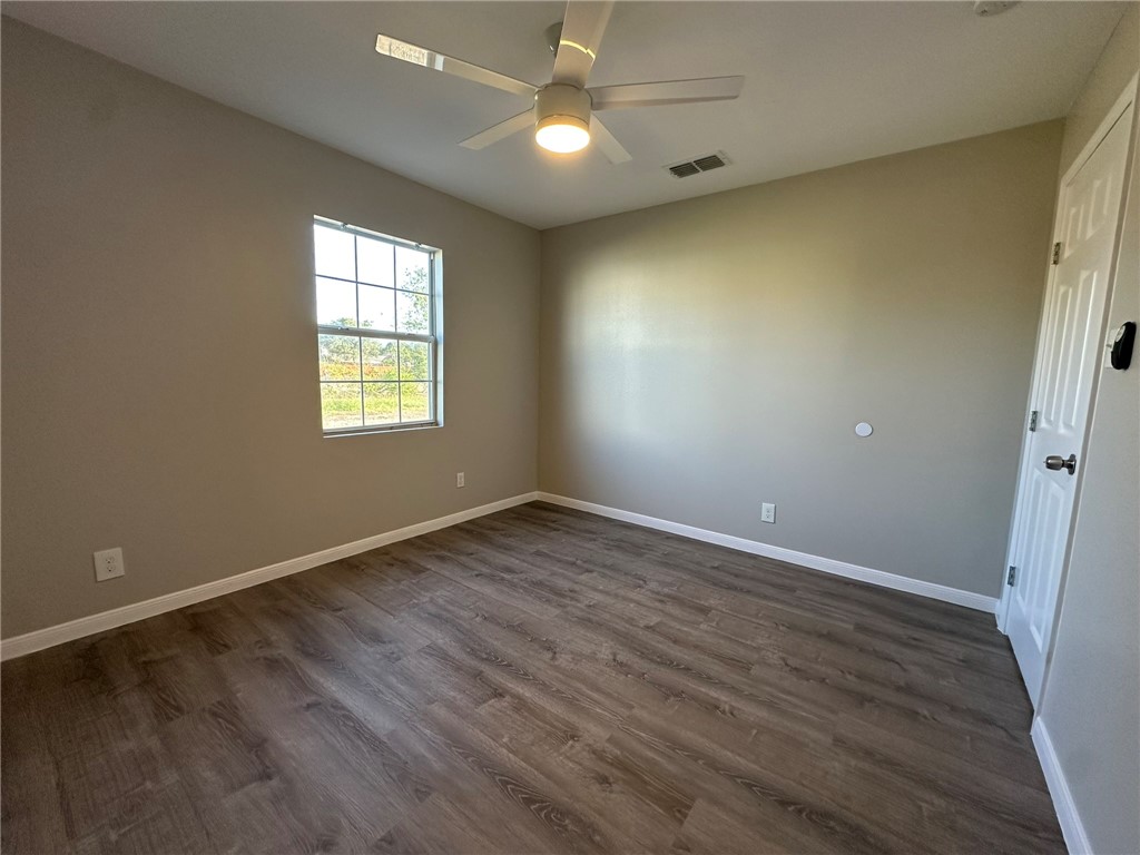 3152 Meadow Lane Robstown, TX 78380 - Photo 20 of 40 an empty room with wooden floor and windows
