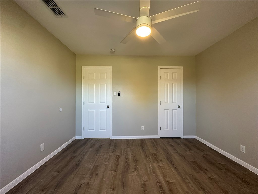 3152 Meadow Lane Robstown, TX 78380 - Photo 23 of 40 an empty room with wooden floor and windows