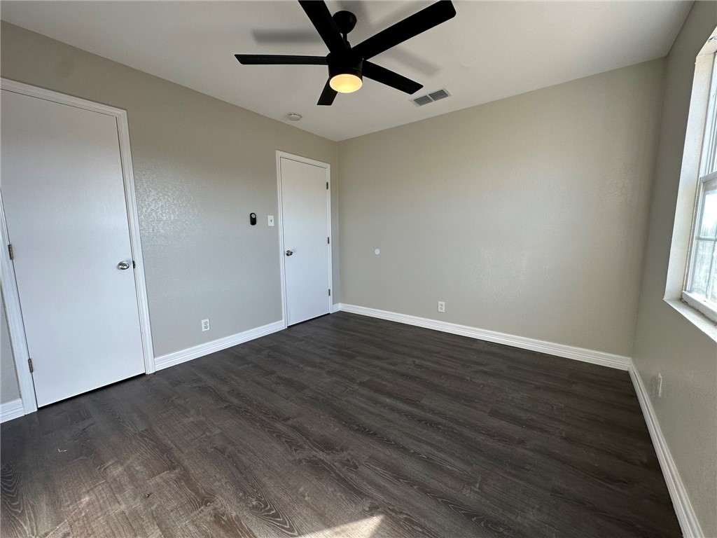 3152 Meadow Lane Robstown, TX 78380 - Photo 29 of 40 an empty room with wooden floor and windows