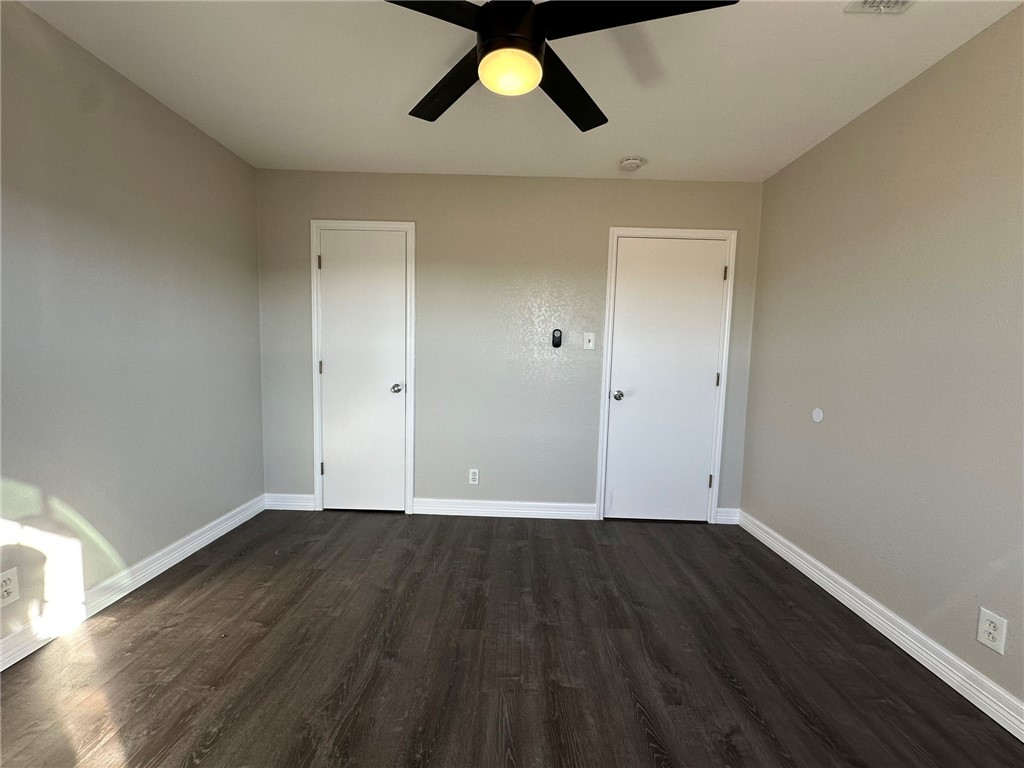 3152 Meadow Lane Robstown, TX 78380 - Photo 30 of 40 an empty room with wooden floor and windows