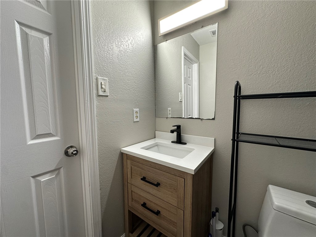 3152 Meadow Lane Robstown, TX 78380 - Photo 34 of 40 a bathroom with a sink toilet and mirror