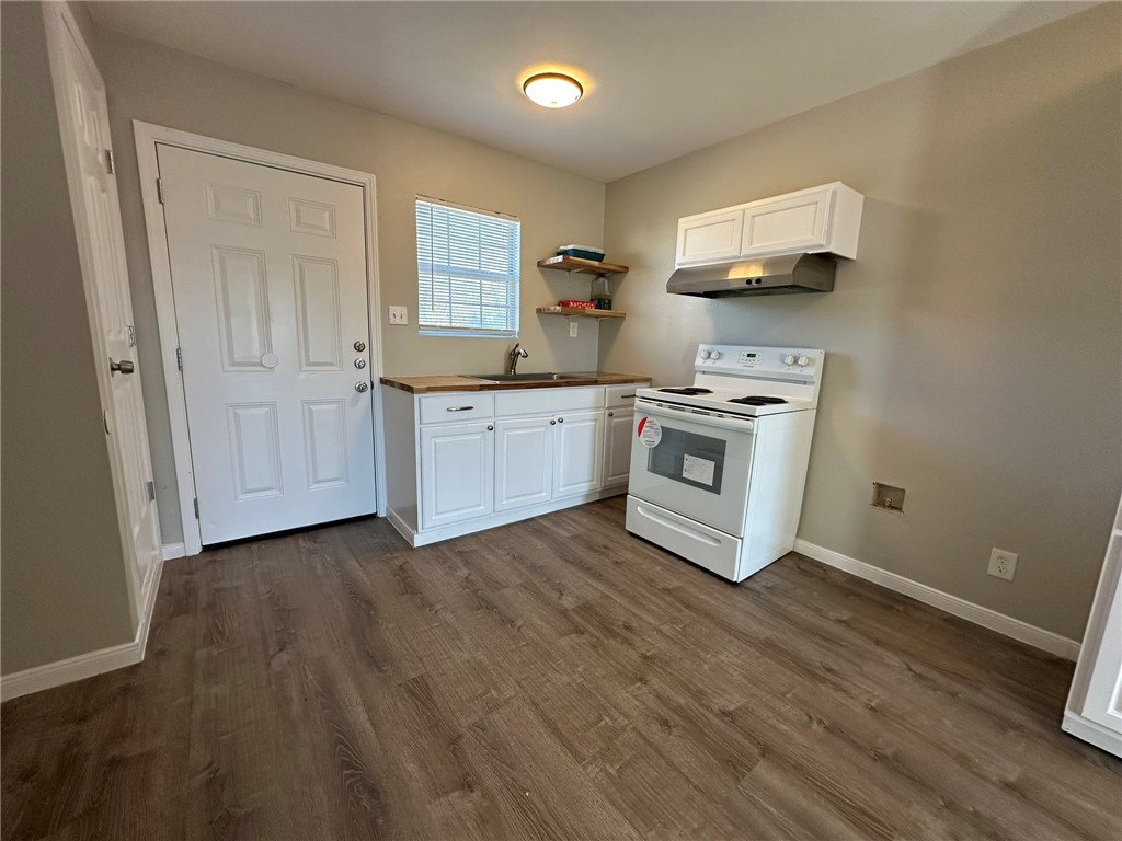 3152 Meadow Lane Robstown, TX 78380 - Photo 8 of 40 a kitchen with stainless steel appliances granite countertop a stove a sink and a microwave