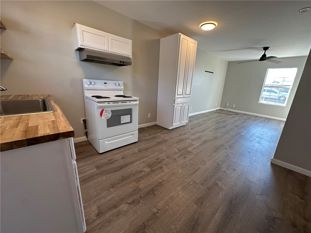 3152 Meadow Lane Robstown, TX 78380 - Photo 10 of 40 a kitchen with stainless steel appliances granite countertop a stove and a refrigerator