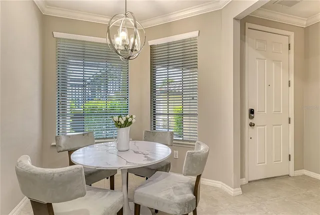 a view of a dining room with furniture and window