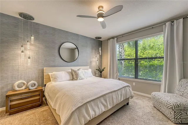 a bedroom with a bed and a large window