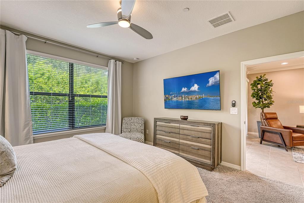 5420 Cicerone Street, Unit 101 Sarasota, FL 34238 - Photo 15 of 40 a bedroom with a bed and a flat screen tv