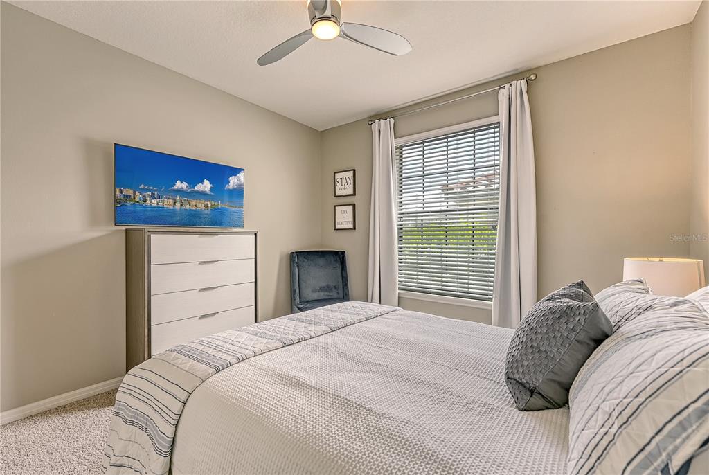 5420 Cicerone Street, Unit 101 Sarasota, FL 34238 - Photo 20 of 40 a bedroom with a bed and a flat screen tv