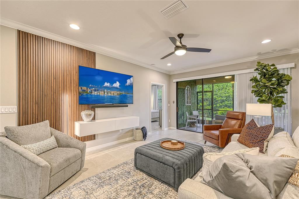 5420 Cicerone Street, Unit 101 Sarasota, FL 34238 - Photo 2 of 40 a living room with furniture and a flat screen tv