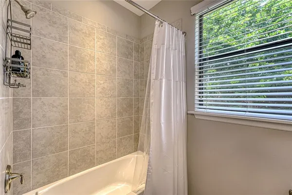 a bath tub sitting next to a window