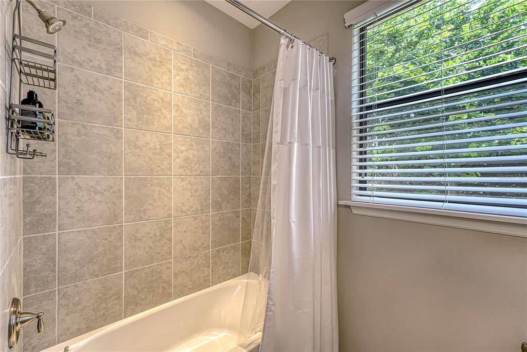5420 Cicerone Street, Unit 101 Sarasota, FL 34238 - Photo 22 of 40 a bath tub sitting next to a window
