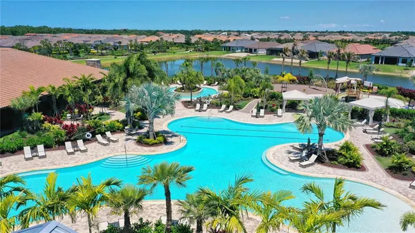 an outdoor space with swimming pool and green space