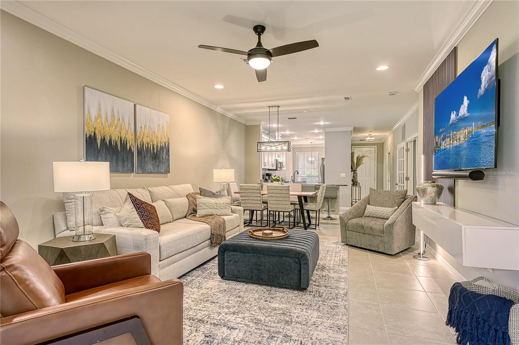 5420 Cicerone Street, Unit 101 Sarasota, FL 34238 - Photo 4 of 40 a living room with furniture ceiling fan and a rug